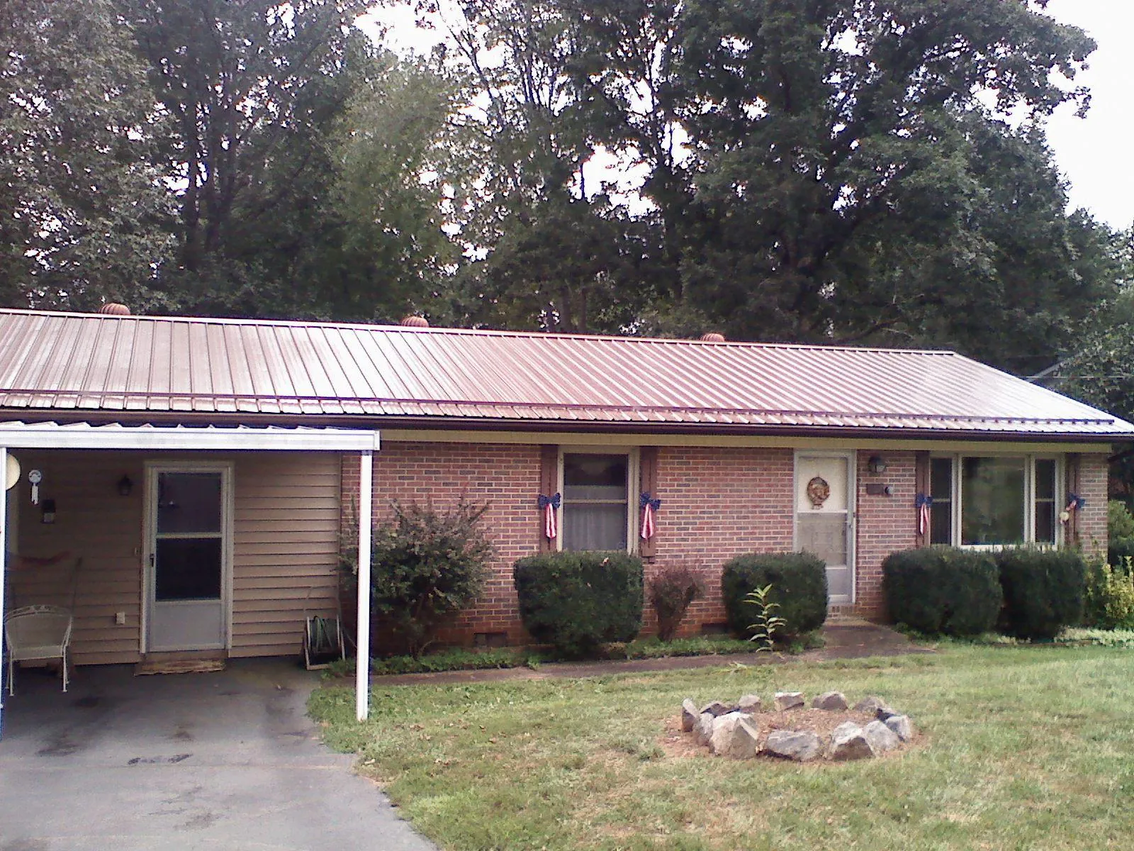 Bronze metal roof and carport on a brick ranch home — Roof Repair work by our crew in Hacienda Heights